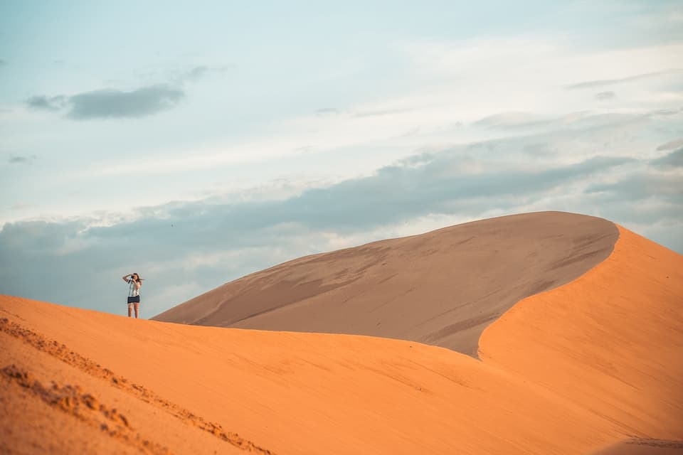 A man standing on sand dune